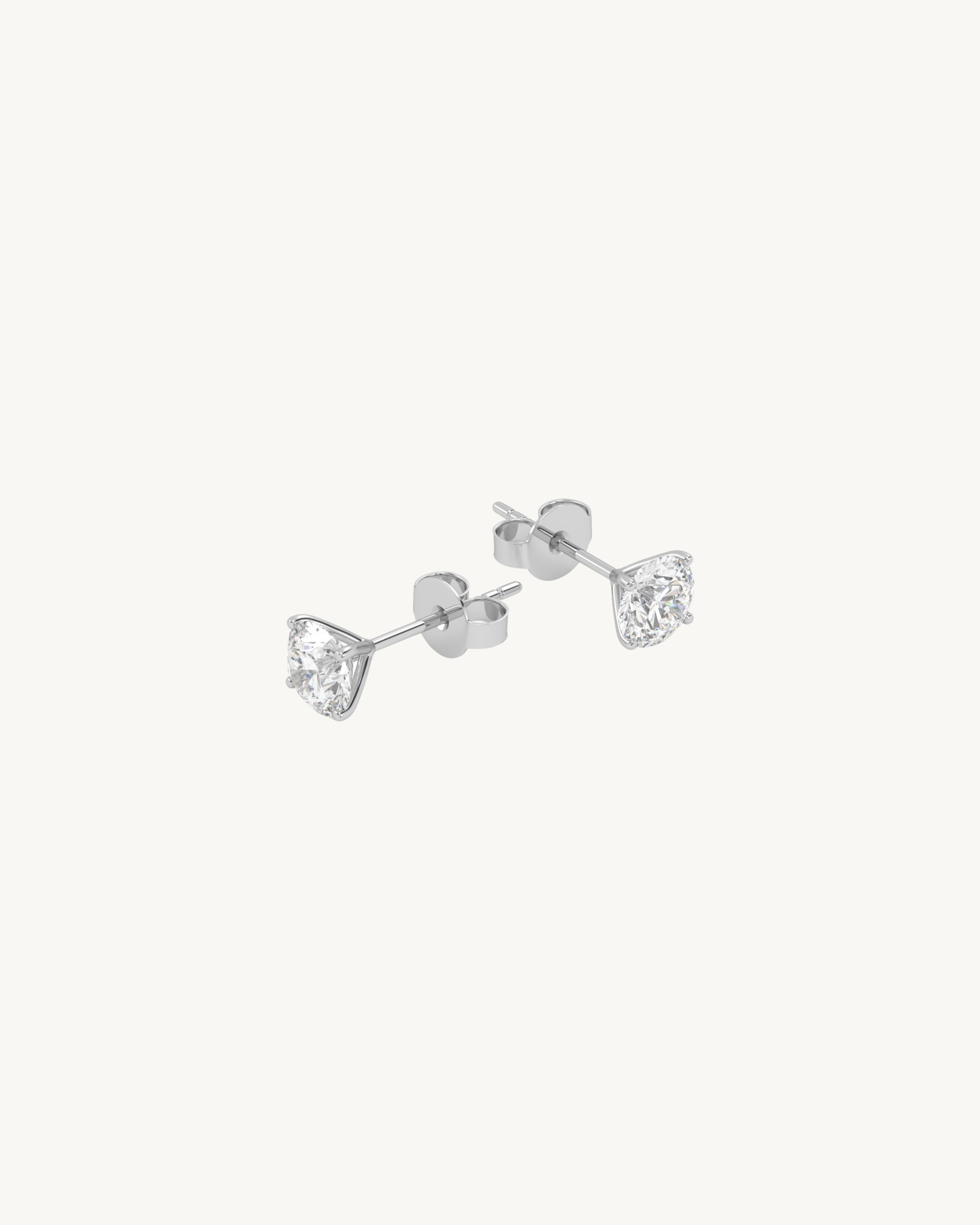 Pair of diamond gold stud earrings on a white background