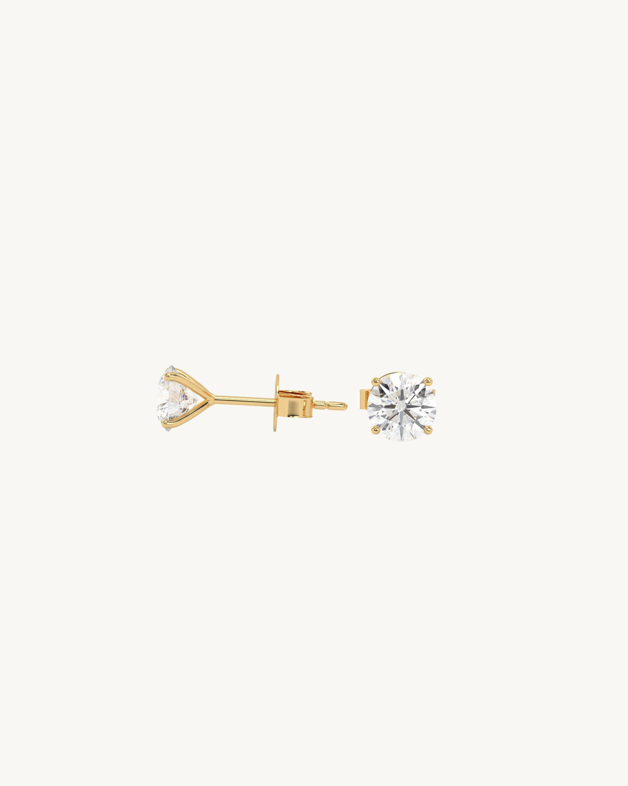 Pair of gold and diamond stud earrings on a white background