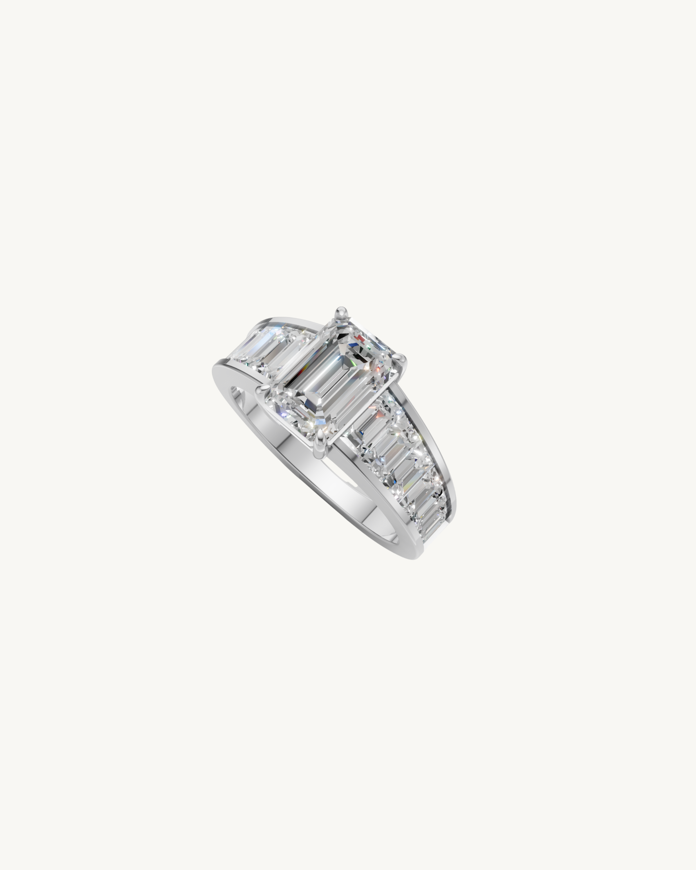 Diamond ring with emerald cut center stone and a gold band with tapered baguette diamonds