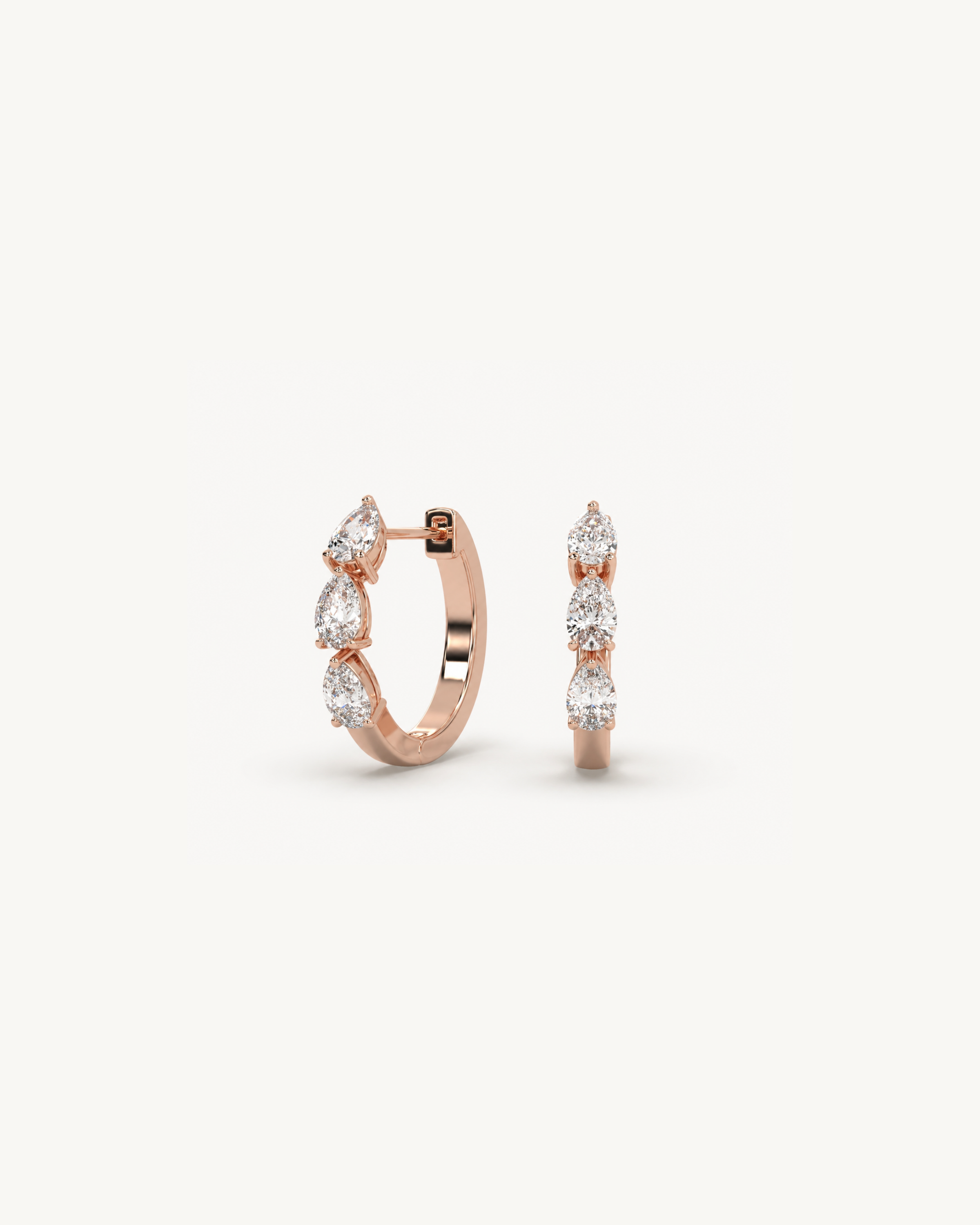 Rose gold hoop earrings with clear gemstones on a white background