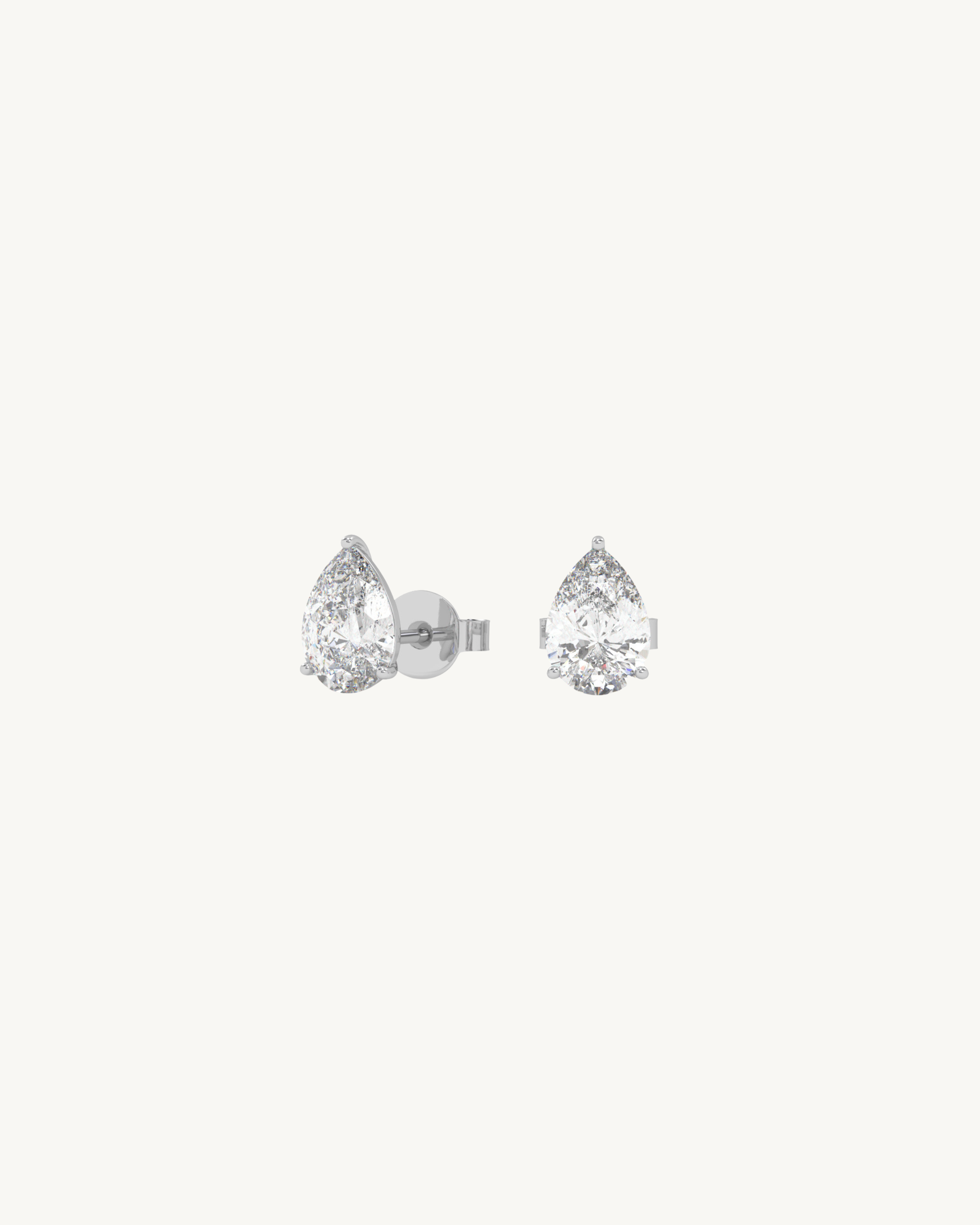 Teardrop-shaped diamond earrings on a white background