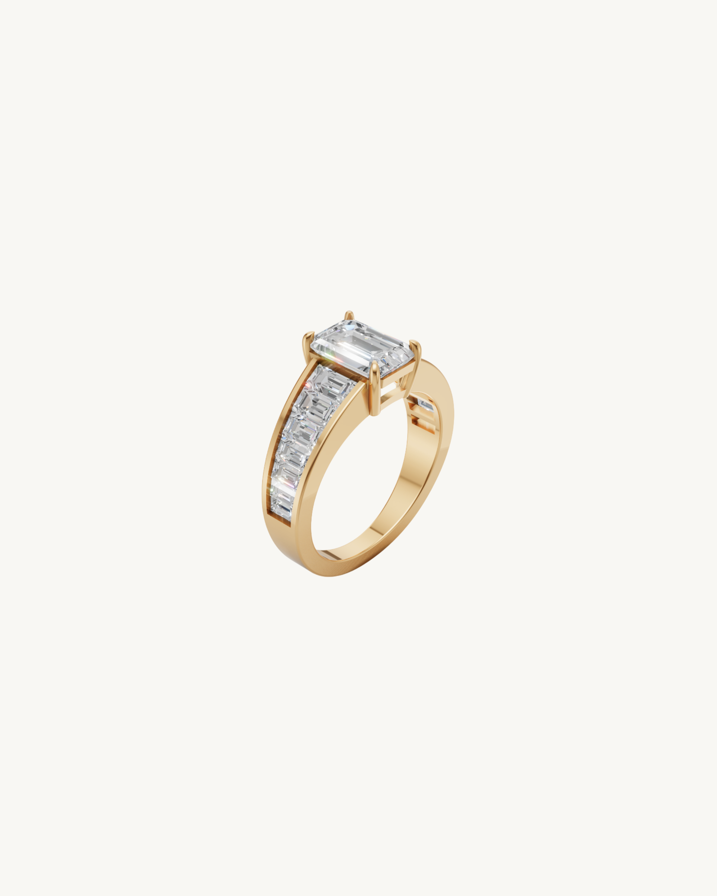 Diamond ring with emerald cut center stone and a gold band with tapered baguette diamonds