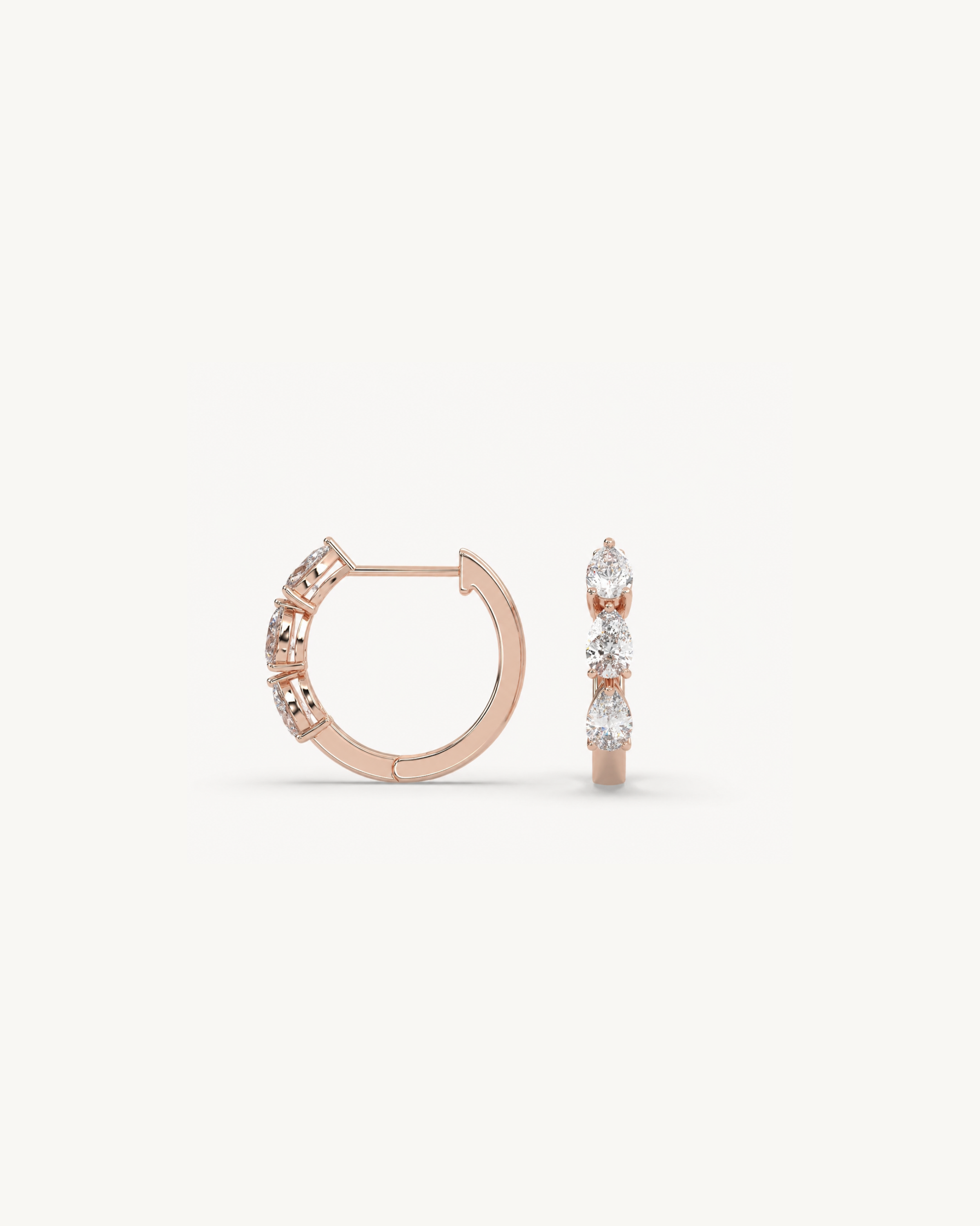 Rose gold hoop earrings with diamond accents on a white background
