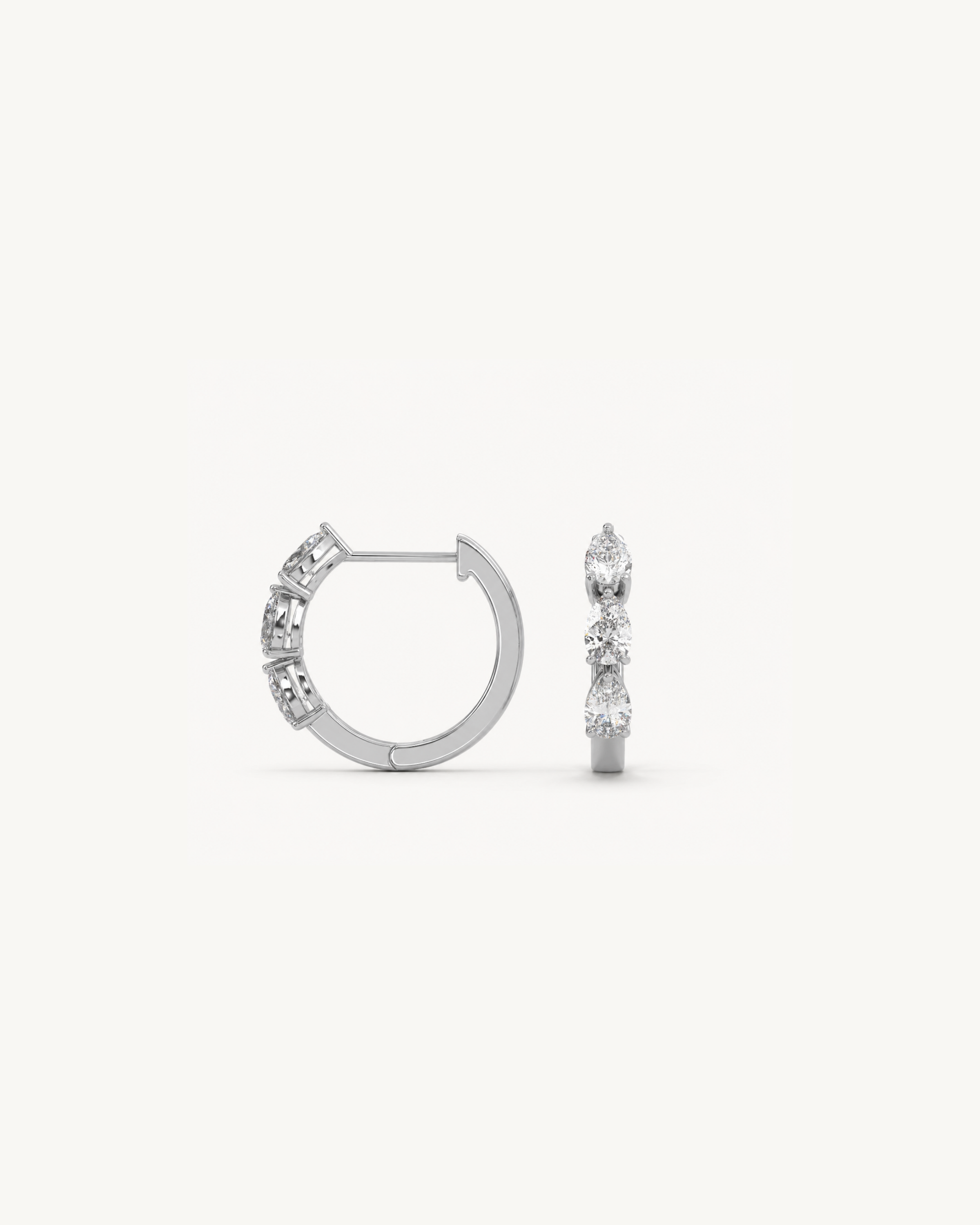 Pair of white gold hoop earrings with pear shaped diamonds