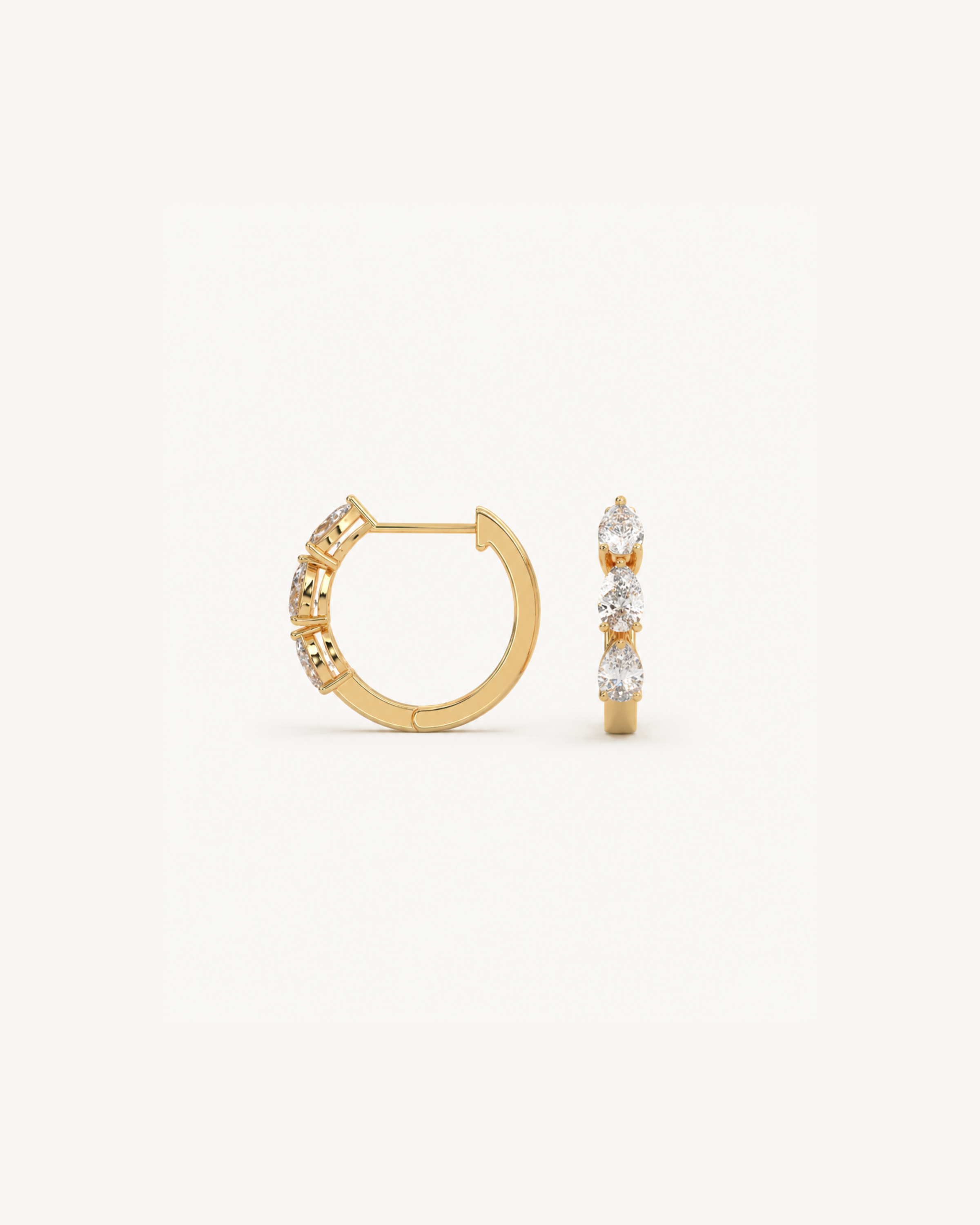 Gold hoop earrings with embedded stones on a white background